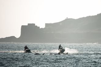 Jet skis approaching bottlenose dolphins near Falmouth by St Mawes Photography