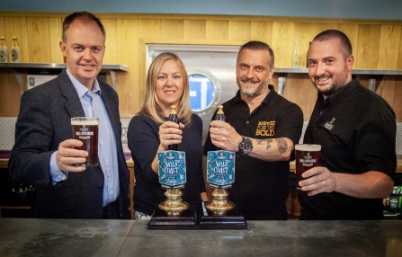 From L-R Piers Thompson, Carolyn Cadman, Tony Wilson and Rob Orton pour a pint of Wild Coast beer