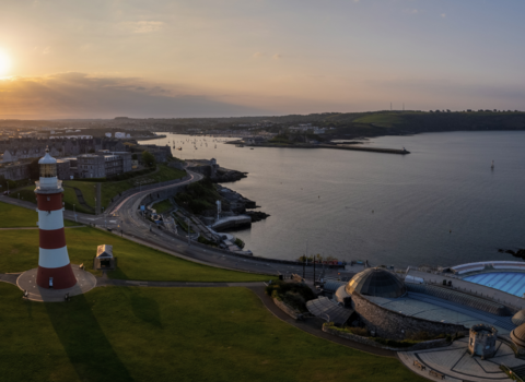 An aerial shot of Plymouth Hoe at dusk. Plymouth Sound can be seen to the right of the image